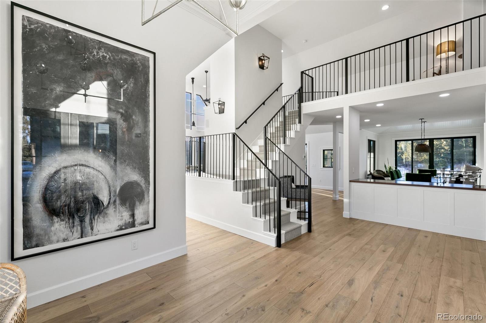 1128 County Road 65 Evergreen, CO 80439 - Photo 7 of 40 a view of staircase with white walls and a painting on the wall