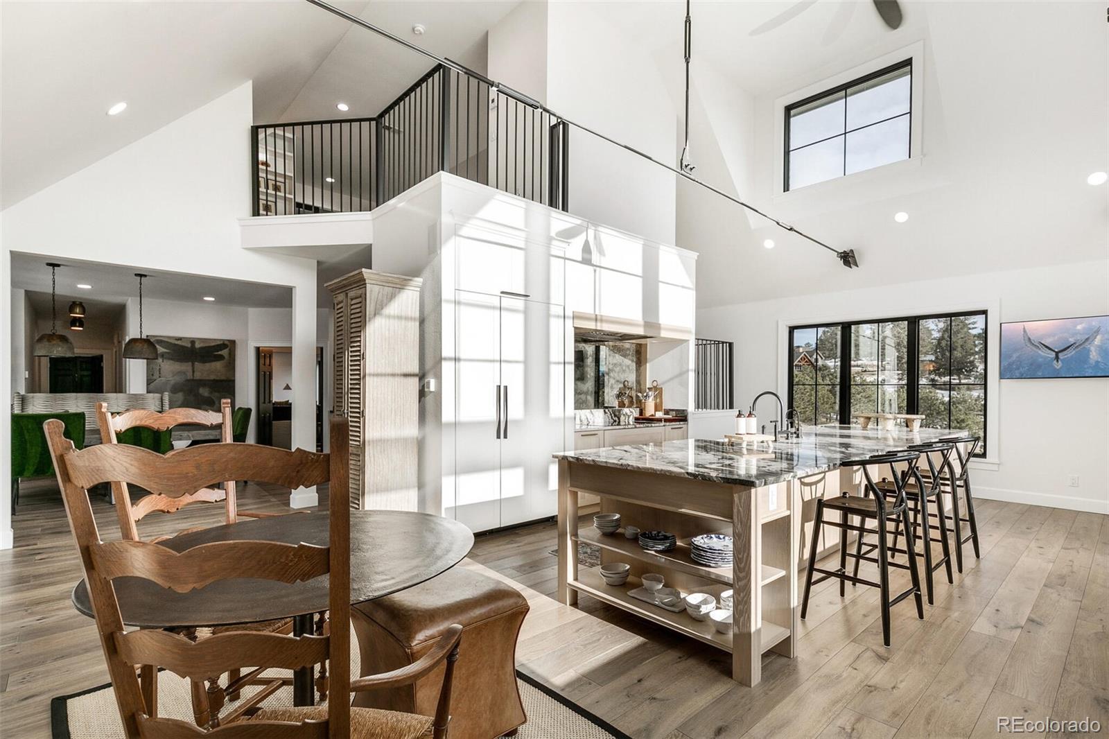 1128 County Road 65 Evergreen, CO 80439 - Photo 8 of 40 a view of a dining room with furniture window and wooden floor