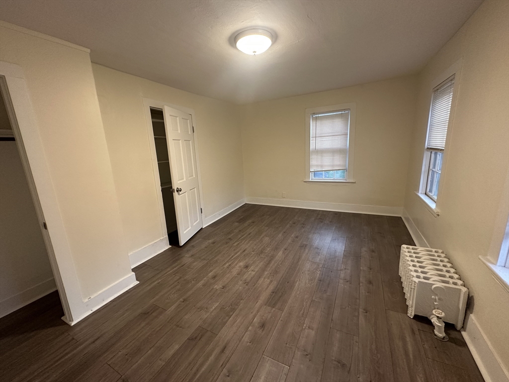 1024-1026 Waverly Street, Unit 3 Framingham, MA 01702 - Photo 18 of 22 a view of an empty room with wooden floor and a window