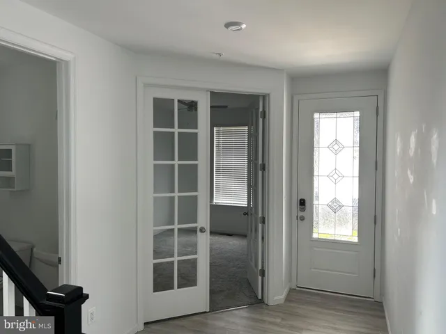 an empty room with windows and cabinet