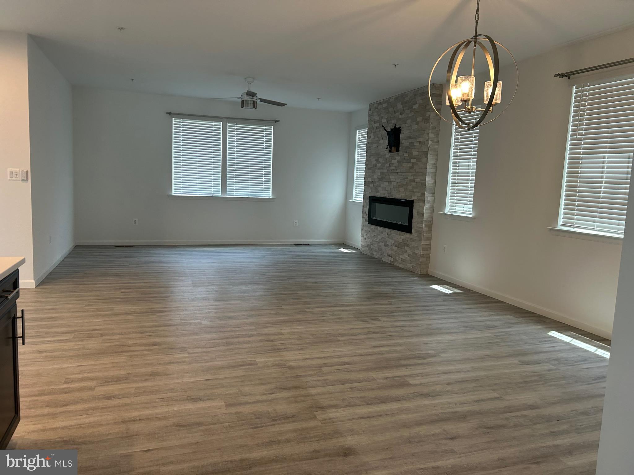 2703 Grasshopper Drive Odenton, MD 21113 - Photo 13 of 14 an empty room with wooden floor fan and windows
