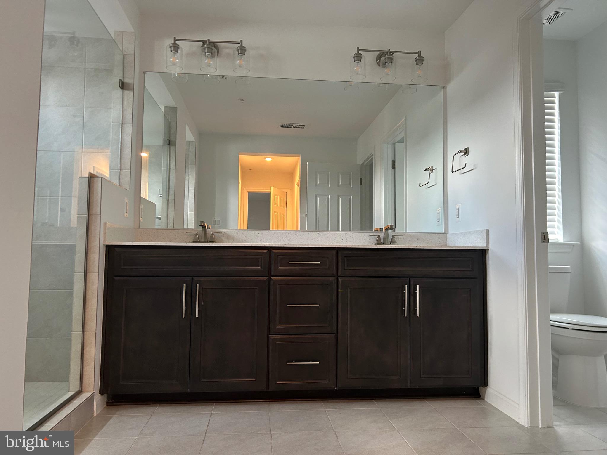 2703 Grasshopper Drive Odenton, MD 21113 - Photo 8 of 14 a bathroom with a granite countertop sink and a mirror