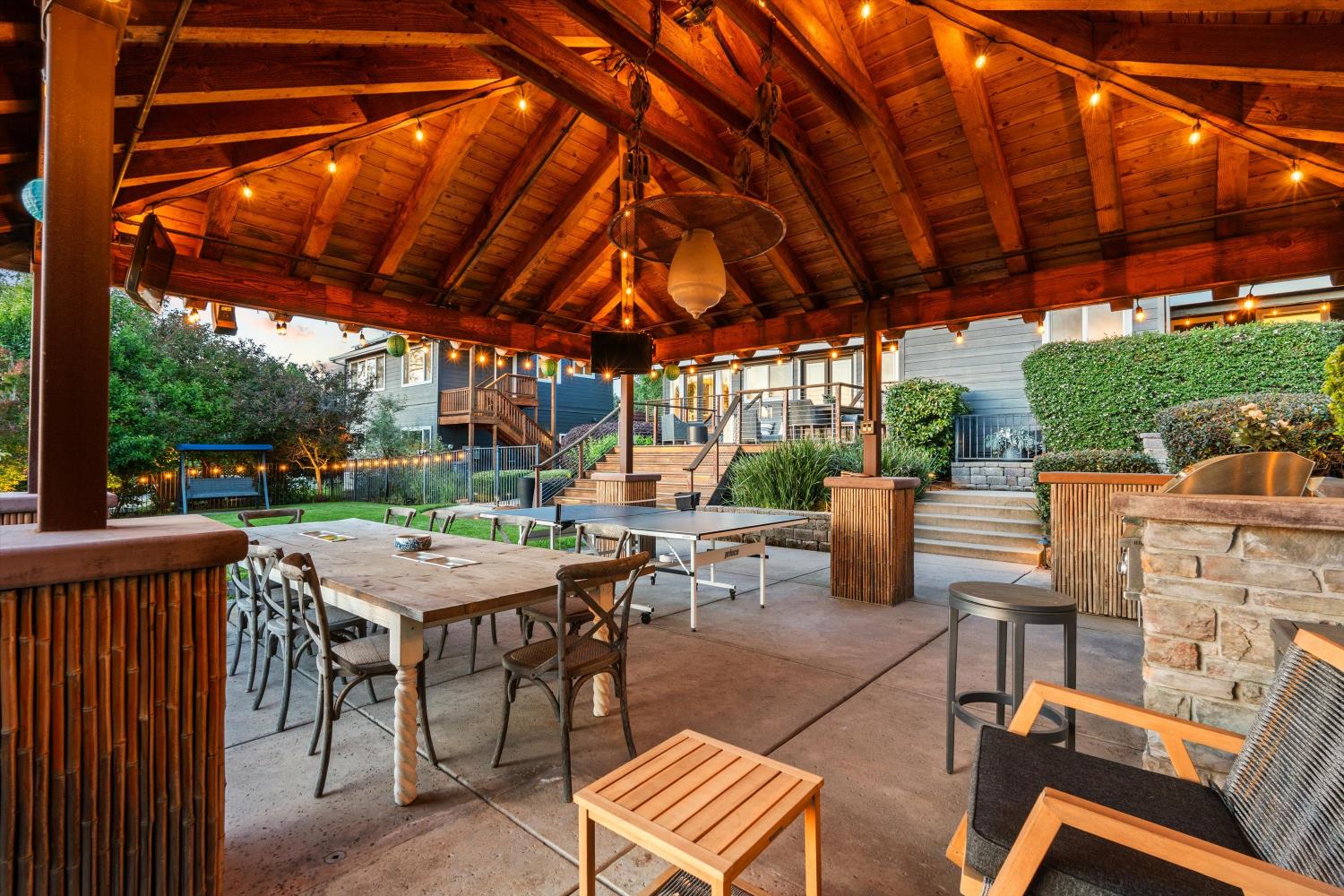 7380 Ridge Road Newcastle, CA 95658 - Photo 82 of 97 a view of a patio with a table and chairs under a large umbrella with a small yard