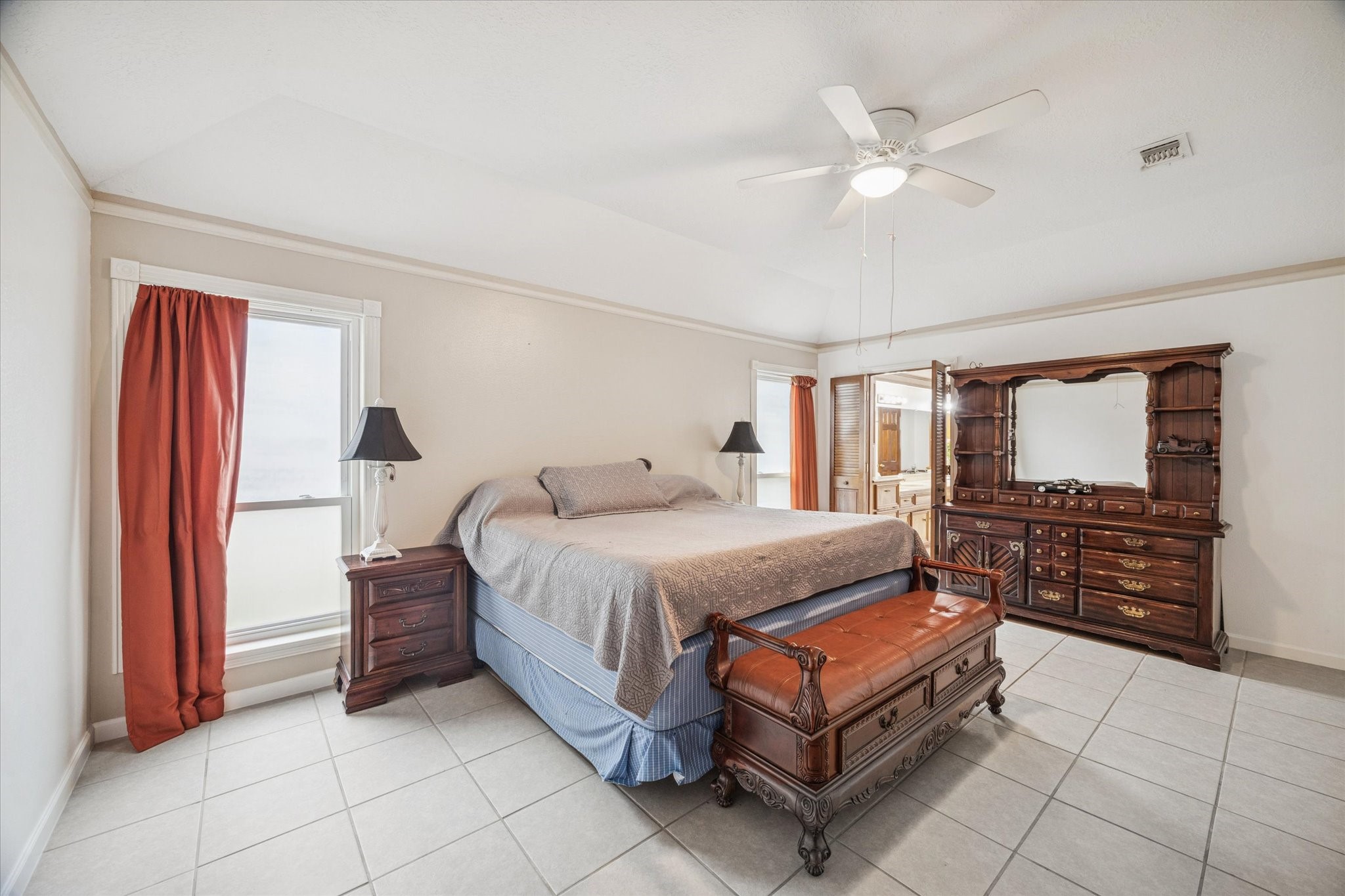6723 Apple Valley Lane Houston, TX 77069 - Photo 12 of 25 a bedroom with a bed and a chandelier