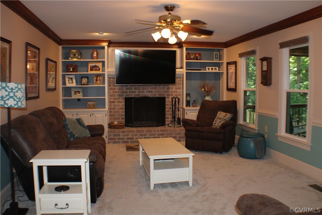 504 Rivers Bend Circle Chester, VA 23836 - Photo 15 of 50 a living room with furniture a flat screen tv and a fireplace