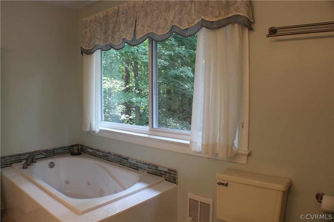 504 Rivers Bend Circle Chester, VA 23836 - Photo 23 of 50 a bathroom with a tub and a window