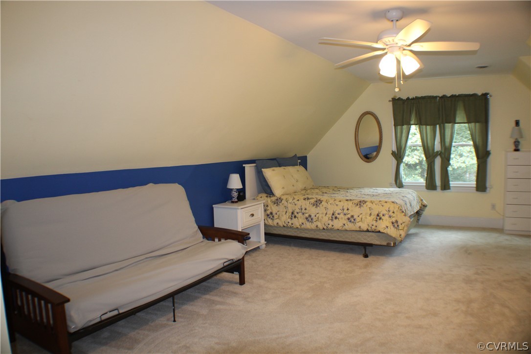 504 Rivers Bend Circle Chester, VA 23836 - Photo 25 of 50 a bedroom with a bed and a chandelier