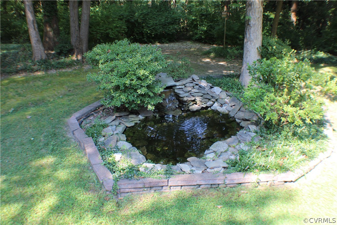 504 Rivers Bend Circle Chester, VA 23836 - Photo 45 of 50 a view of a garden with a bench