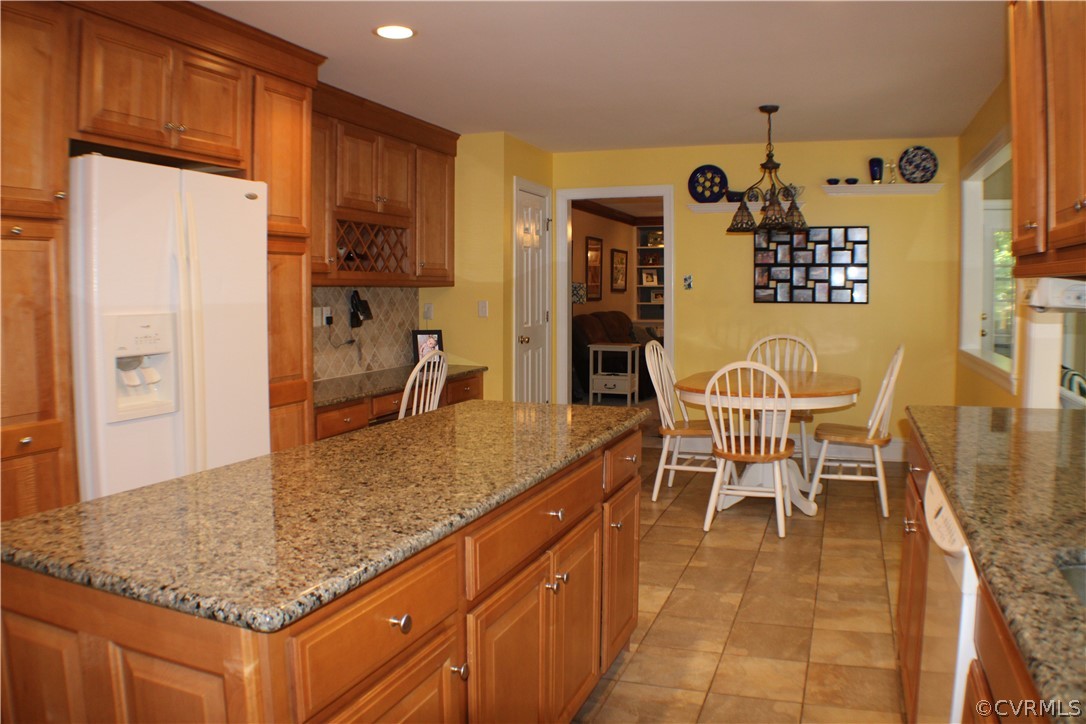 504 Rivers Bend Circle Chester, VA 23836 - Photo 8 of 50 a kitchen with stainless steel appliances granite countertop a sink and a refrigerator