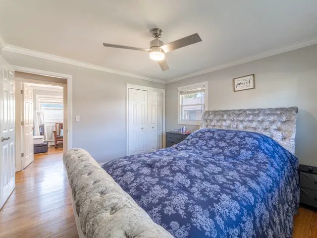 a bedroom with a large bed and a chandelier