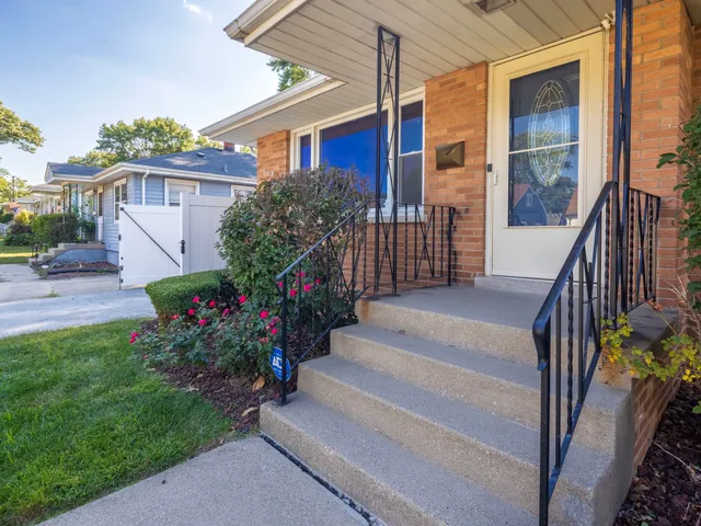 a view of a house with wooden fence and garden