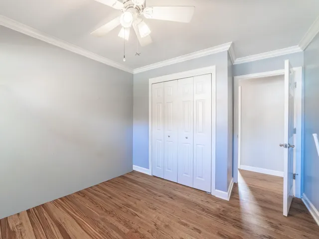 a view of a room with wooden floor and closet area