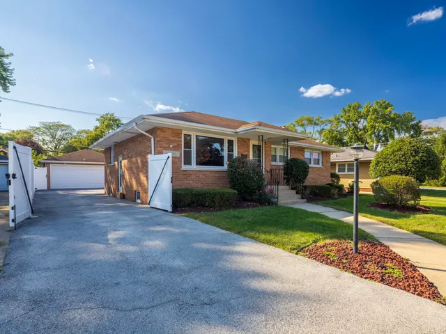 a view of a house with a patio and a yard