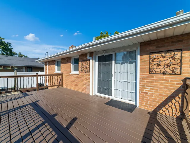 a view of a house with wooden deck
