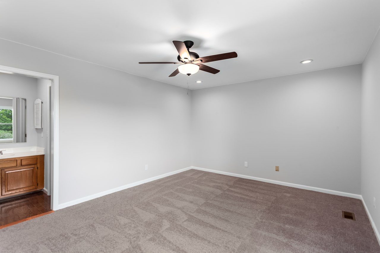 6903 Saxby Court Raleigh, NC 27613 - Photo 7 of 11 The spacious master bedroom is fresh, bright and inviting with its recent facelift and new ceiling fan! Master Bedroom