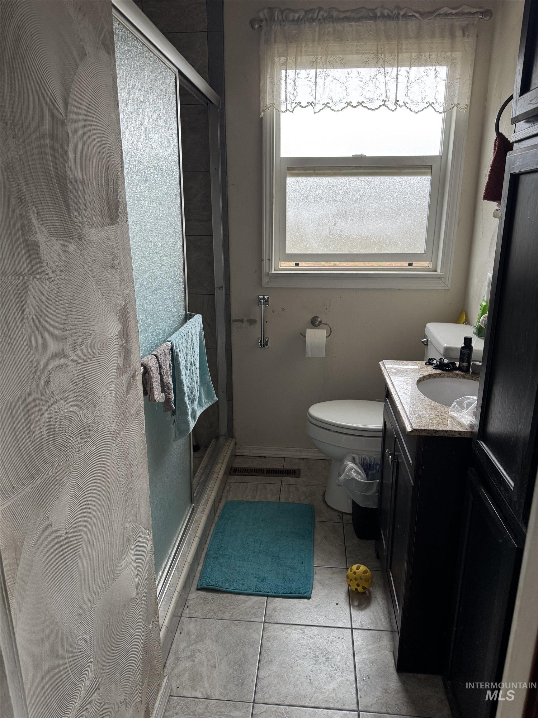 416 North 2nd Street Nyssa, OR 97913 - Photo 6 of 24 Full bathroom featuring vanity, a shower stall, and light tile patterned floors