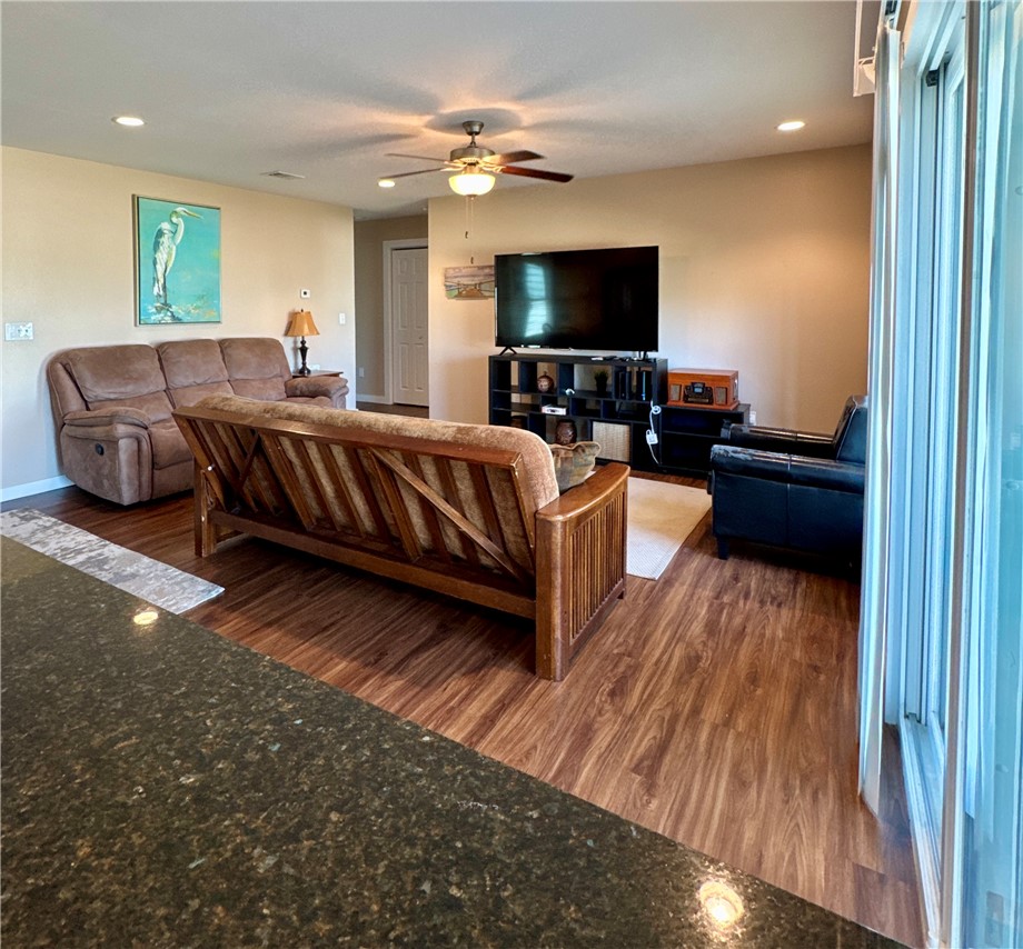 230 Cut-Off Road, Unit B107 Port Aransas, TX 78373 - Photo 4 of 25 a living room with a bed furniture and a flat screen tv