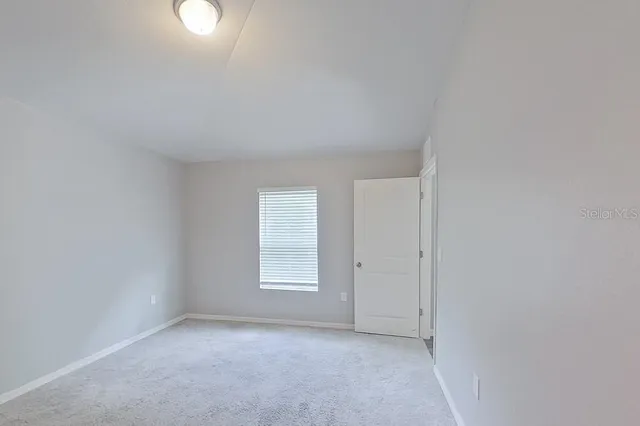 a bathroom with a granite countertop double vanity sinks and a mirror