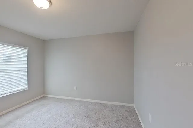 a view of an empty room and a window