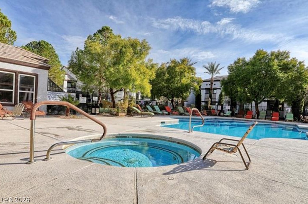 7255 West Sunset Road, Unit 2111 Las Vegas, NV 89113 - Photo 2 of 33 An inviting outdoor pool area, complete with a spa, offers a perfect setting for leisure and enjoyment.