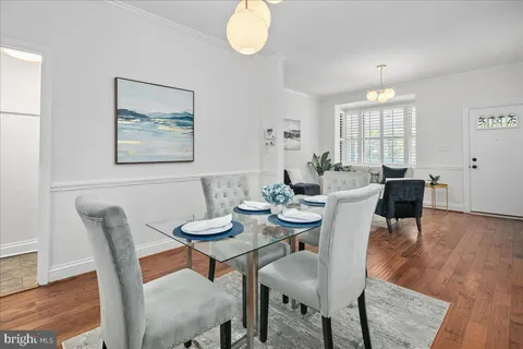 a view of a dining room with furniture wooden floor and chandelier