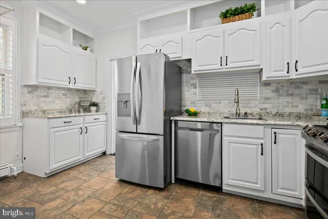 a kitchen with appliances cabinets and a sink