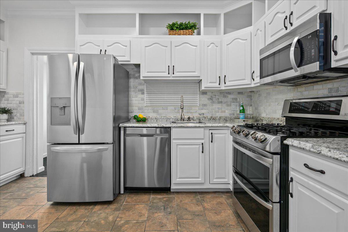 6411 7th Street Northwest Washington, DC 20012 - Photo 13 of 35 a kitchen with stainless steel appliances granite countertop a refrigerator a stove and a sink