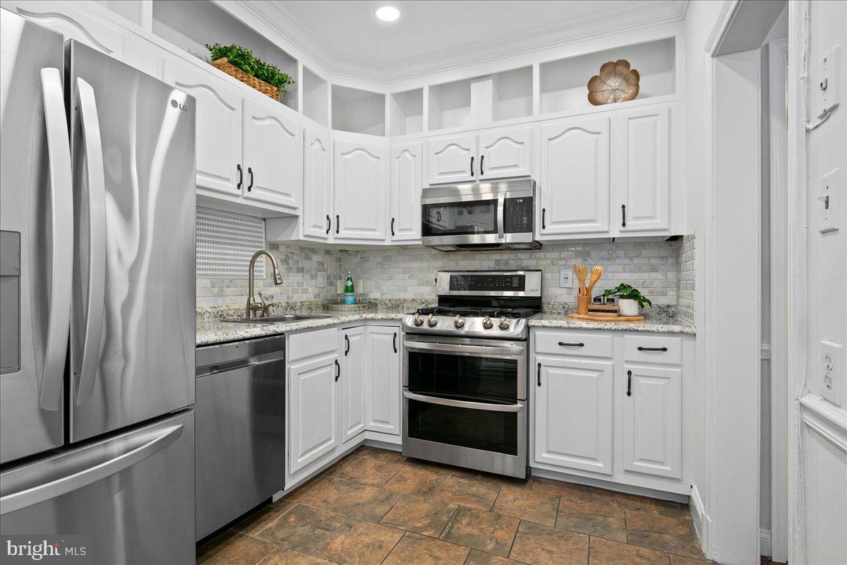 6411 7th Street Northwest Washington, DC 20012 - Photo 14 of 35 a kitchen with stainless steel appliances granite countertop a refrigerator sink and stove