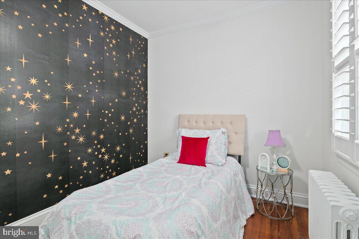 6411 7th Street Northwest Washington, DC 20012 - Photo 20 of 35 a bedroom with a bed and a chandelier