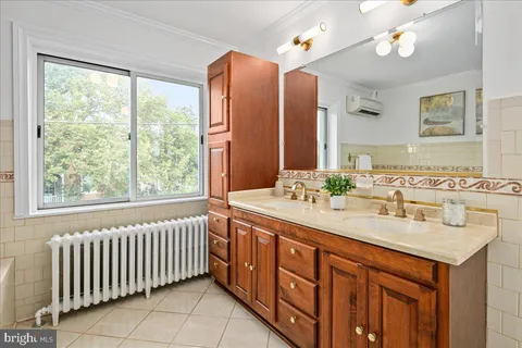 a bathroom with a double vanity sink and a mirror