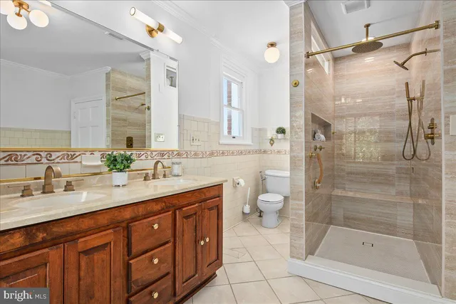 a bathroom with a shower sink vanity mirror and toilet