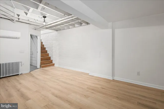 a view of a room with wooden floor