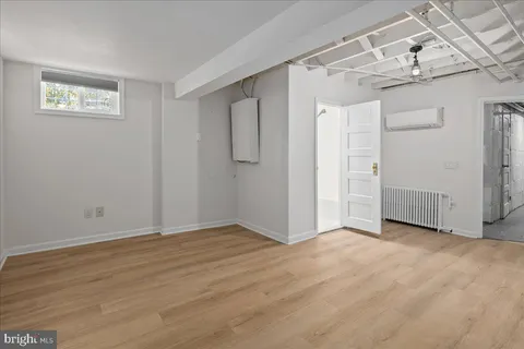 a view of a big room with wooden floor and closet