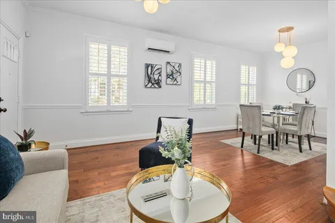 a living room with furniture chandelier and window