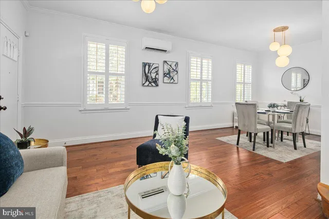a living room with furniture chandelier and window