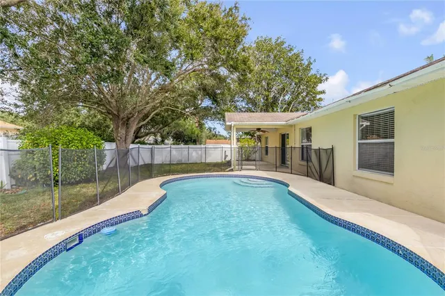 a view of a backyard with swimming pool