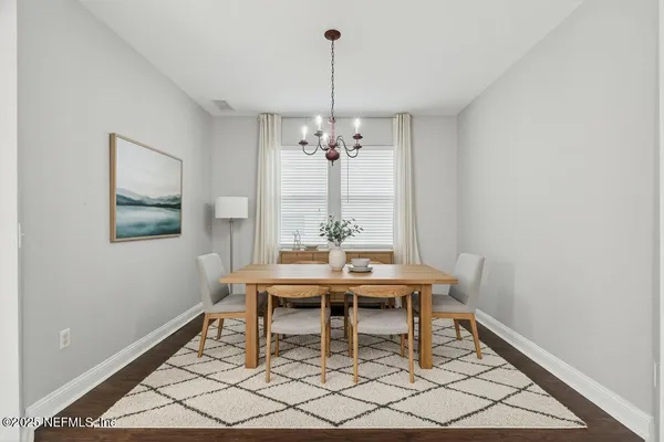 a view of a dining room with furniture and window