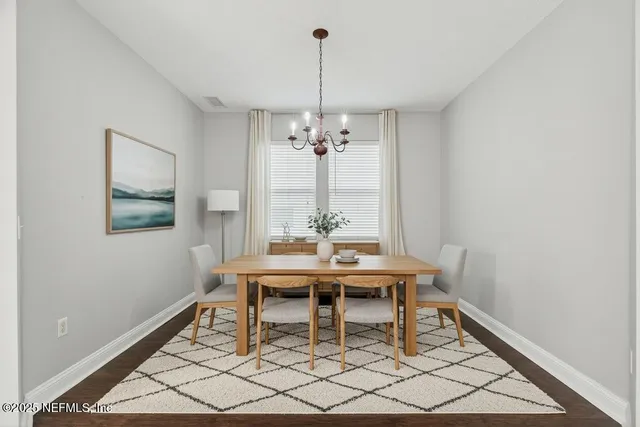 a view of a dining room with furniture and window