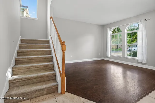 a view of entryway with wooden floor and stairs