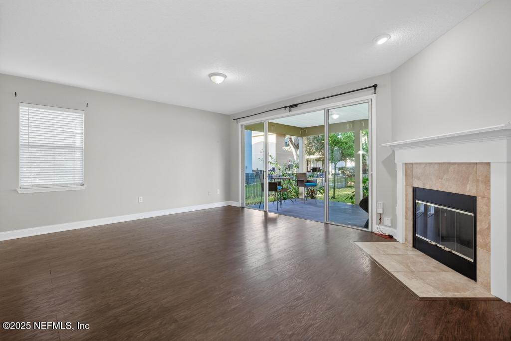 612 Spruce Creek Road St. Johns, FL 32259 - Photo 18 of 50 a view of an empty room with a fireplace and a window