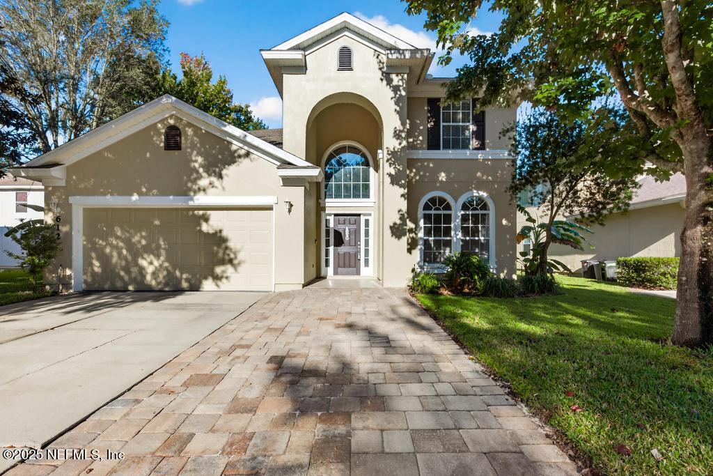 612 Spruce Creek Road St. Johns, FL 32259 - Photo 2 of 50 a front view of a house with garden