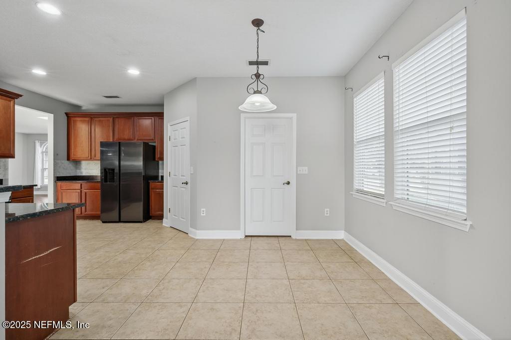 612 Spruce Creek Road St. Johns, FL 32259 - Photo 25 of 50 a view of a kitchen with refrigerator and windows