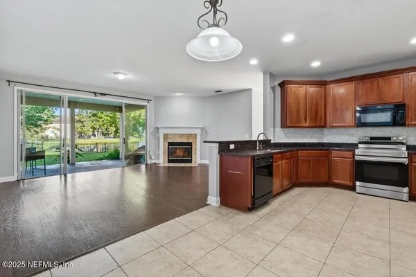 a kitchen with stainless steel appliances granite countertop a stove sink and cabinets