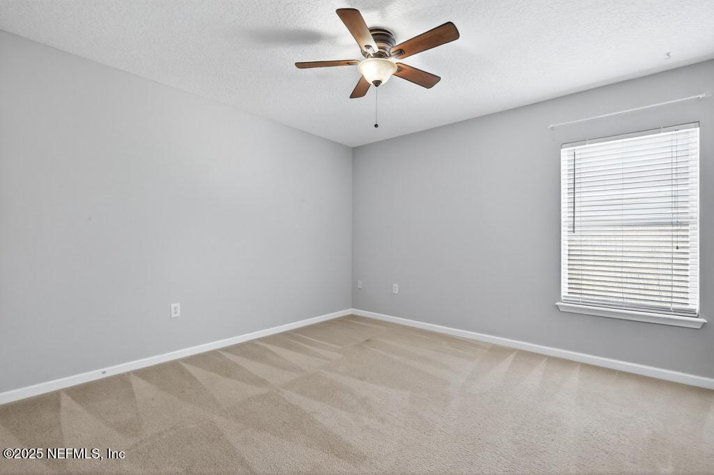 612 Spruce Creek Road St. Johns, FL 32259 - Photo 31 of 50 an empty room with a window and a fan