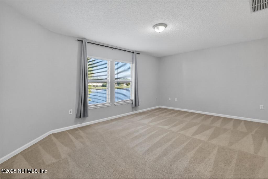 612 Spruce Creek Road St. Johns, FL 32259 - Photo 32 of 50 a view of an empty room with a window