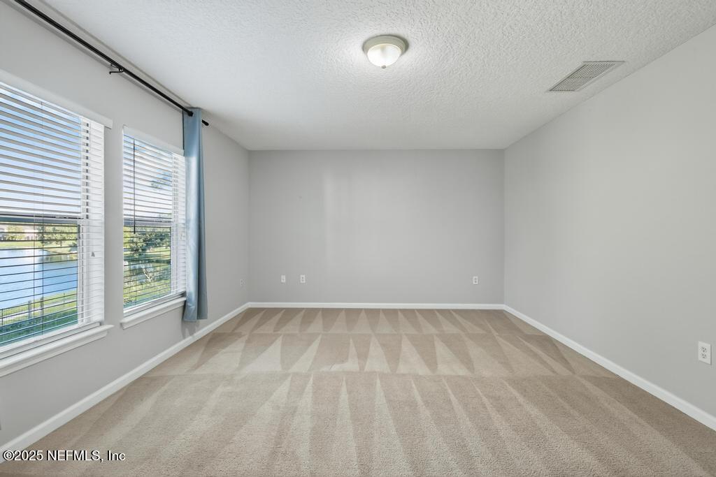 612 Spruce Creek Road St. Johns, FL 32259 - Photo 33 of 50 wooden floor in an empty room with a window