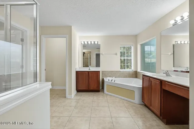 a large bathroom with a large tub and sink
