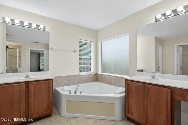 a bath tub sitting next to a bathroom sink