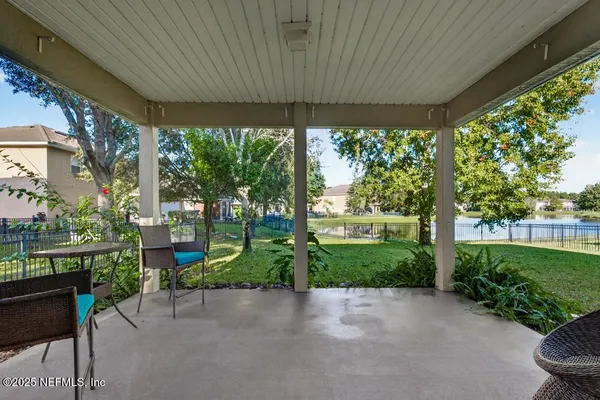 a view of a porch with furniture and garden