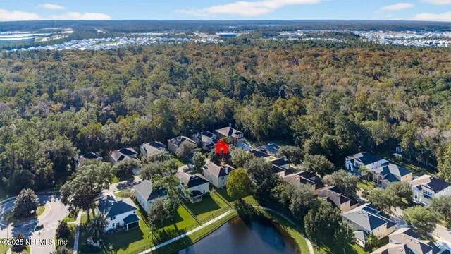 an aerial view of a houses with a lush green hillside
